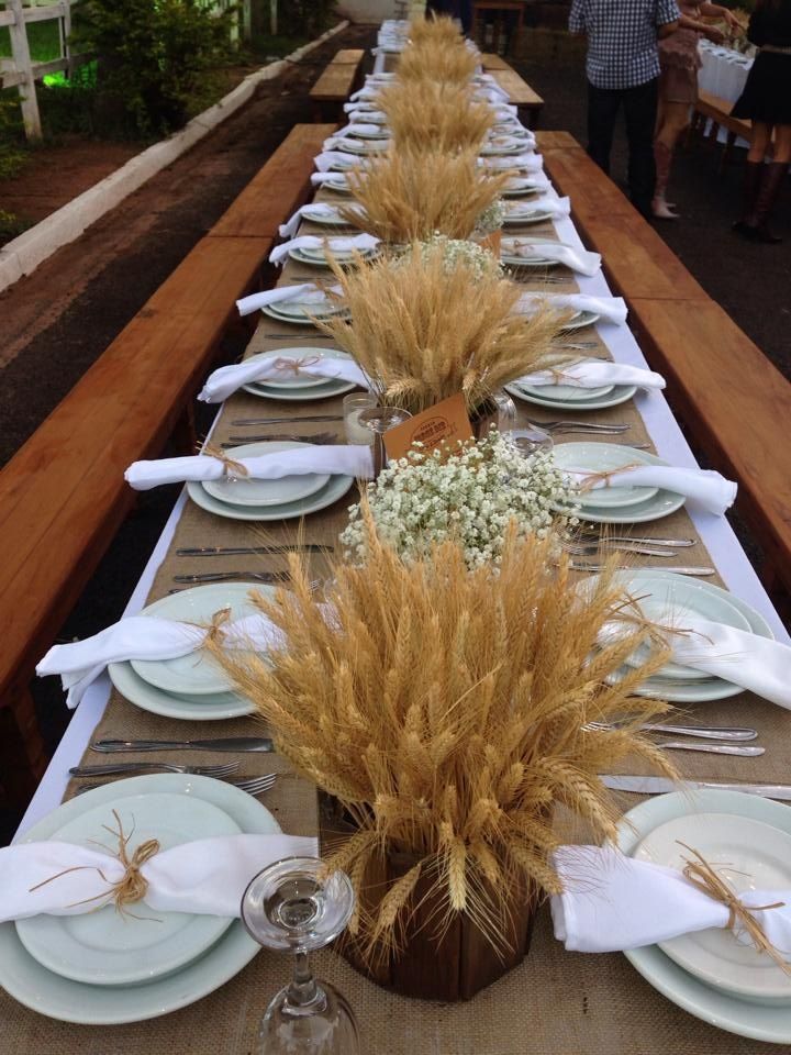 a long table is set with plates and place settings for an outdoor dinner or party