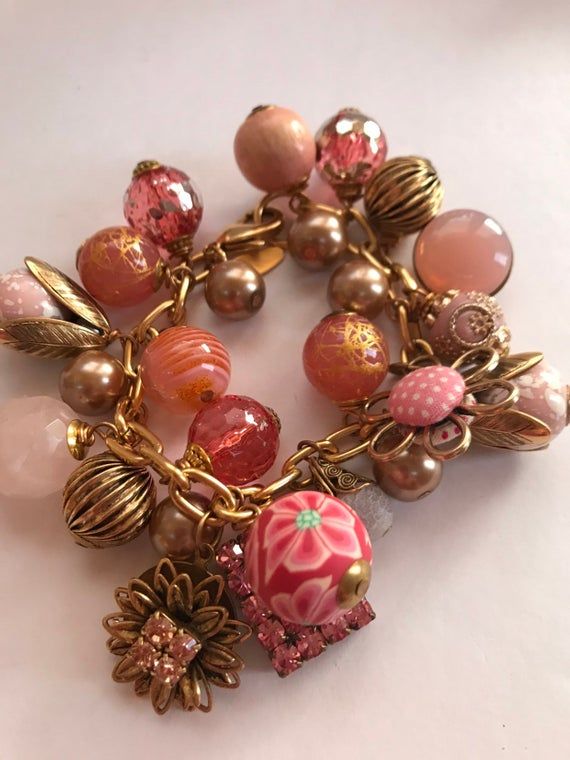 Lenora Dame charmingly pink baubly charm bracelet Handmade Charming Pink Jewelry, Charming Handmade Pink Jewelry, Pink Whimsical Charm Bracelet For Gift, Whimsical Pink Bracelets With Charms, Whimsical Pink Charm Bracelets, Pink Vintage Charm Dangle Jewelry, Vintage Pink Jewelry With Charms, Vintage Pink Charm Jewelry, Pink Vintage Jewelry With Charms