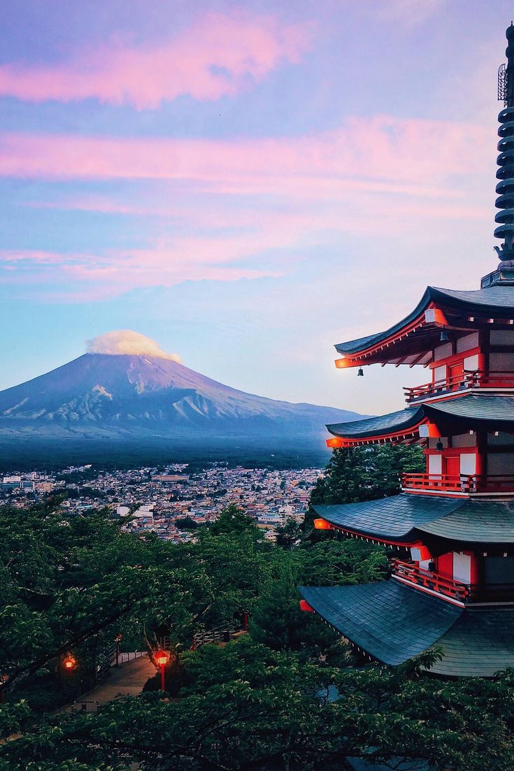 a tall pagoda with a mountain in the background