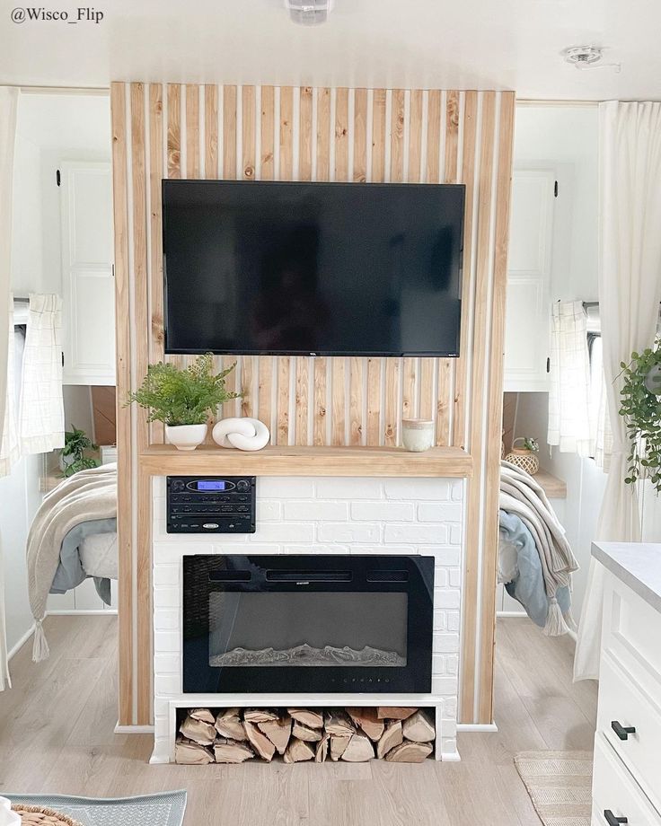 a living room with a fireplace and tv mounted on the wall above it is decorated in wood planks