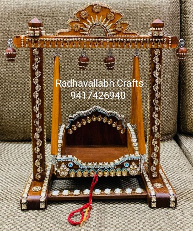 an ornate wooden bed sitting on top of a couch next to a pair of scissors