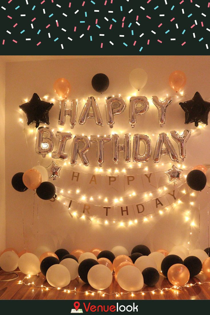 a birthday party with balloons, streamers and confetti on the wall that says happy birthday