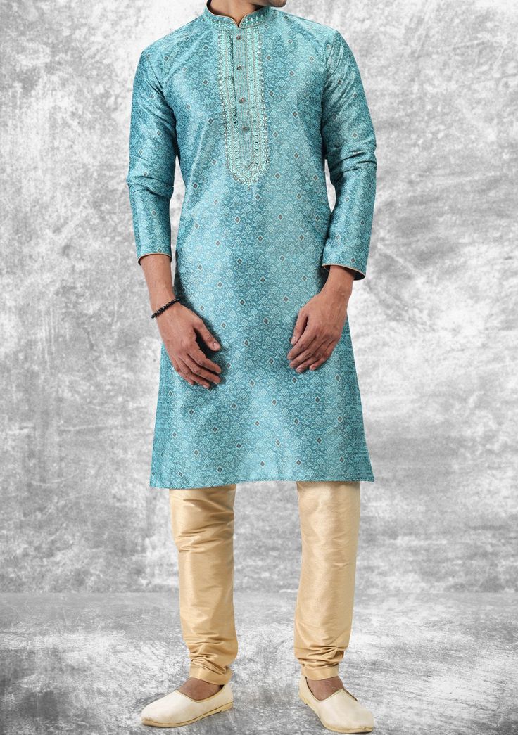 Ready-Made Kurta, With Churidar Pajama. Embroidery, Pintux, and Jacquard Art Silk kurta. Dupion Ready Made Churidar Pajama. Crafted in Chinese Collar Neck, and Full Sleeve. High-Quality Matching Buttons. Please Note: The footwear shown in the picture is for presentation and photography purposes only. Color: There might be slight color variation due to lighting and flashes while the photo shooting. The color may also vary because of different screen resolutions. Wash Care: Dry Clean Only. Eid Brocade Sets With Intricate Embroidery, Brocade Kurta For Eid Party, Festive Churidar With Embroidered Border In Jamawar, Eid Brocade Sets With Resham Embroidery, Festive Jamawar Churidar With Embroidered Border, Festive Brocade Kurta With Intricate Embroidery, Festive Brocade Embroidered Fabric For Eid, Art Silk Churidar With Intricate Embroidery For Eid, Party Embroidered Brocade Kurta