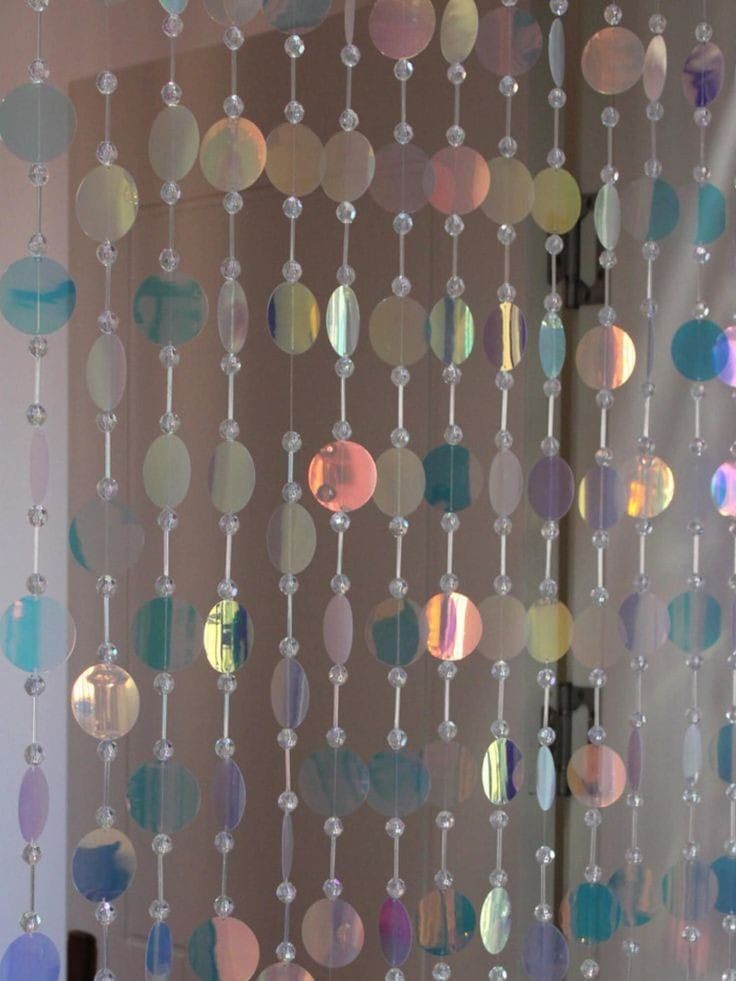 a close up of a curtain made out of glass beads and plastic balls hanging from it's side