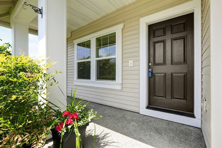 the front door of a house with two planters