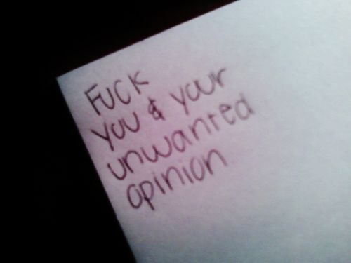 a piece of paper with writing on it that says f k you & your unwanted opinion