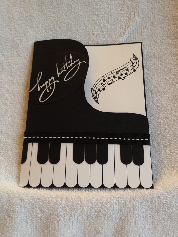 a birthday card with an image of a piano keyboard and musical notes on the front