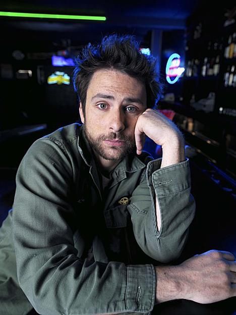 a man sitting at a bar with his hand on his chin and looking off to the side