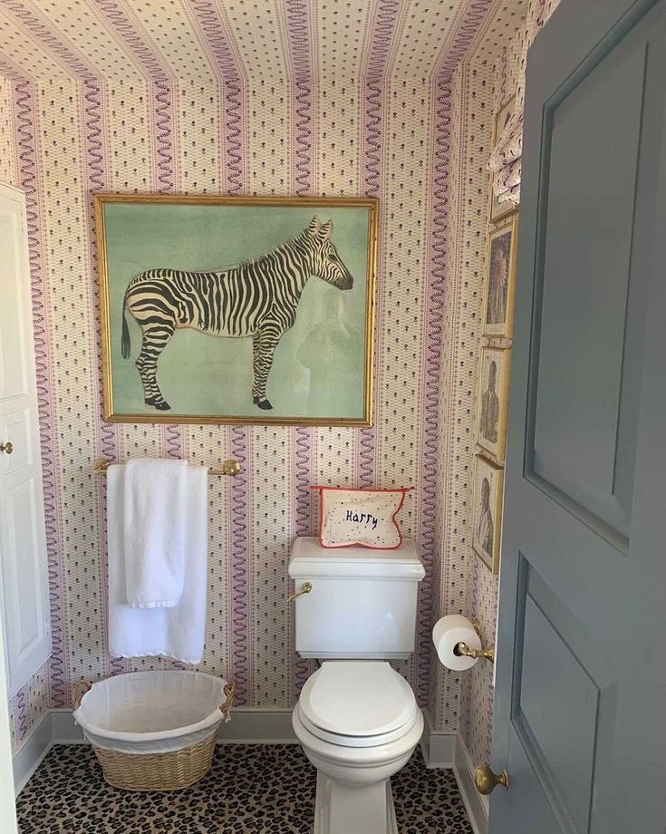 a bathroom with a zebra painting on the wall