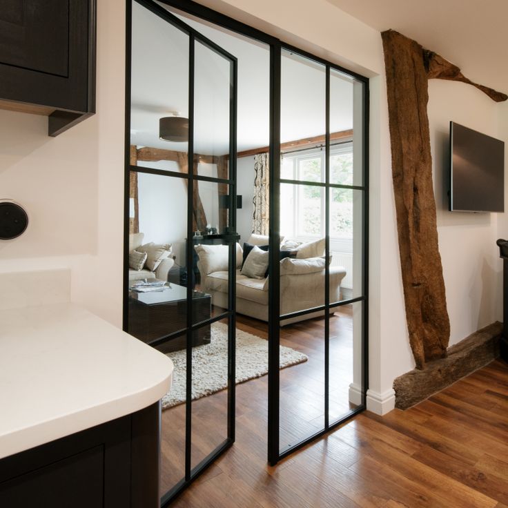 a living room filled with furniture and a flat screen tv on top of a wooden floor