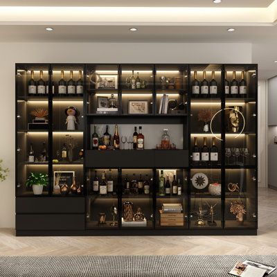 This large and spacious kitchen pantry cabinet combines style and practicality, making it a versatile addition to your kitchen space. Measuring nearly 79" tall and 110" wide, the frame is made from a mix of aluminum, MDF, and glass, and it features a sleek black finish with silver iron hardware. The multi-layer design offers ample storage, including a microwave shelf, drawers, and plenty of shelf space behind glass doors for cutlery, glassware, or other essentials. But the best part? Each shelve Parlour Room, Modern Bar Cabinet, Book Space, Cabinet Storage Solutions, Shower Combo, Modular Display, Speak Easy, Library Bookshelves, Food Pantry Organizing