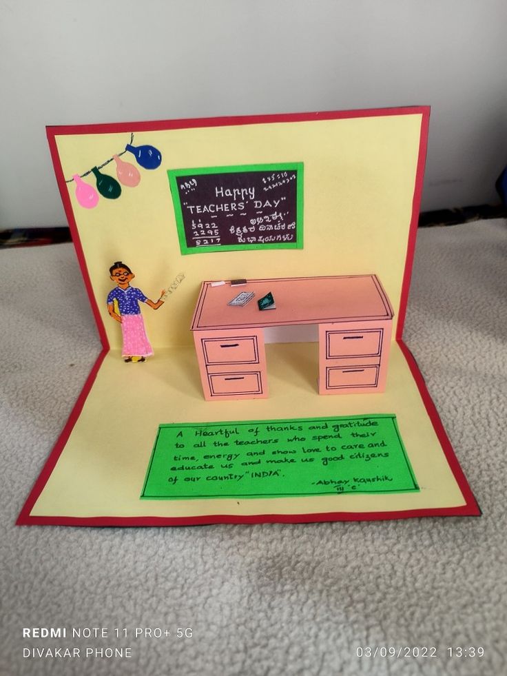 a handmade greeting card with a woman standing in front of a desk