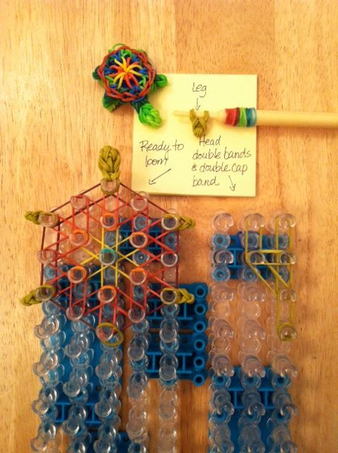 a wooden table topped with lots of plastic beads and magnets on top of it