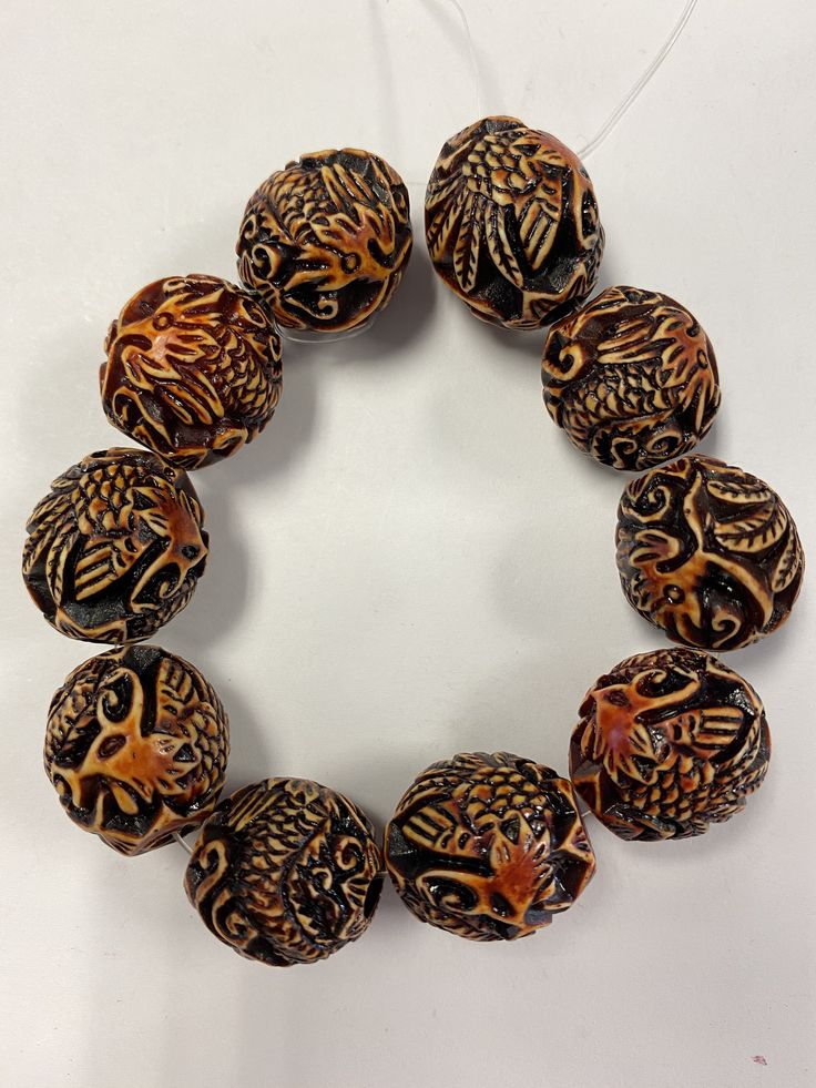 sale price. Spiritual Brown Carved Beads, Wooden Beads For Jewelry Making, Hand-strung Assorted Round Bead Jewelry, Oval Carved Beads For Gifts, Carved Amber Round Beads Jewelry, Unique Carved Beaded Necklace, Brown Round Beads For Gifts, Traditional Brown Beaded Bracelet With Large Beads, Traditional Brown Beaded Bracelets With Large Beads