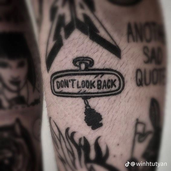 a close up of a person's arm with tattoos on it and the words don't look back