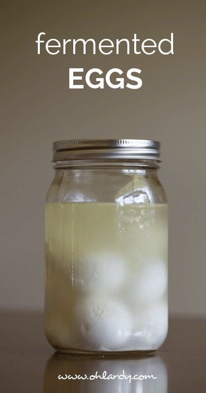 a glass jar filled with eggs on top of a table