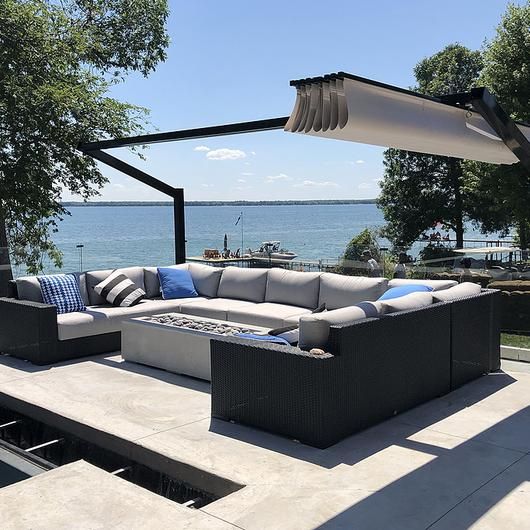 a couch sitting on top of a patio next to a swimming pool