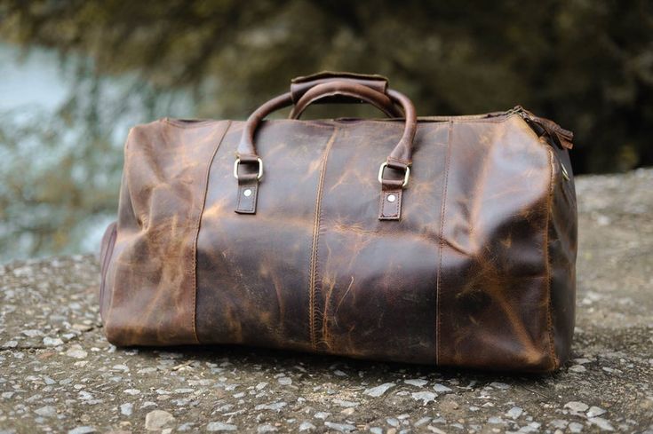 This duffle bag is made with some of the finest genuine leather I've ever seen. It's a great bag to use when packing your clothes and things in, while going on vacation. It's durable and looks fantastic! #leather #leatherbag #bag Rectangular Bag With Waxed Finish For Weekend Trips, Travel Bags With Leather Lining And Canvas Material, Leather Tote Duffle Bag With Waxed Finish, Canvas Travel Bag With Leather Lining, Travel Canvas Bag With Leather Lining, Rectangular Weekender Bag With Leather Backing, Weekend Satchel Bag With Leather Backing, Leather-backed Satchel For Weekend Trips, Brown Coated Canvas Satchel Weekender Bag