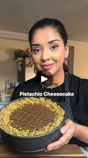 a woman holding a pie in her hands