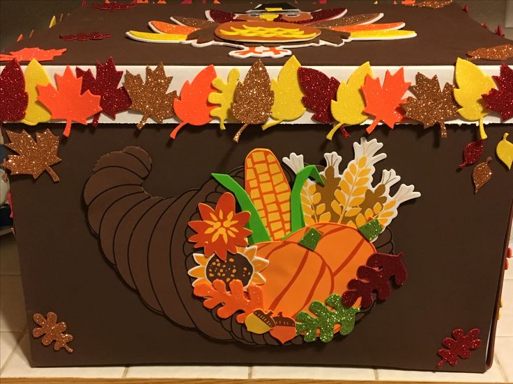 a decorated thanksgiving chest sitting on top of a tiled floor