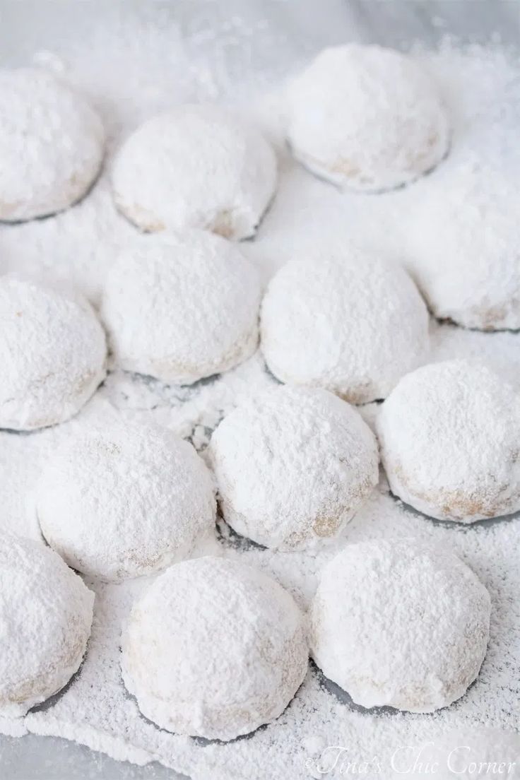 powdered sugar cookies are arranged on a towel