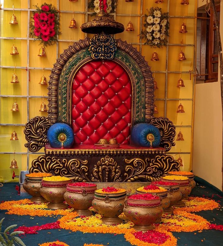 an elaborately decorated room with pots and flowers on the floor in front of it