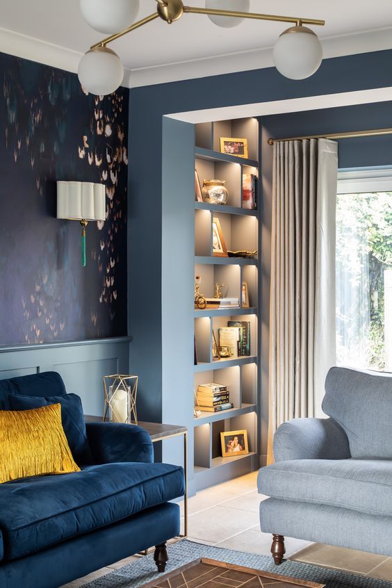 a living room with blue walls and furniture