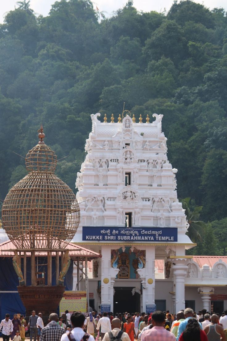 a group of people standing in front of a white temple