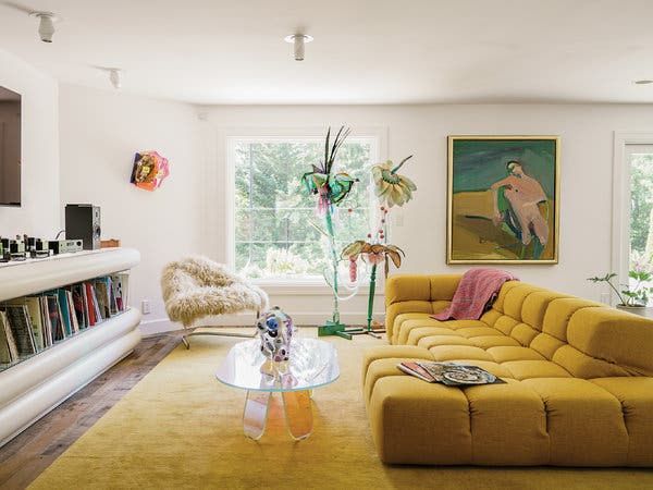 a living room filled with furniture and a fire place next to a painting on the wall