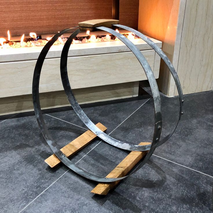 a metal sculpture with candles in the background and a window behind it that is lit