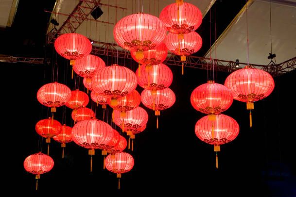 many red lanterns are hanging from the ceiling