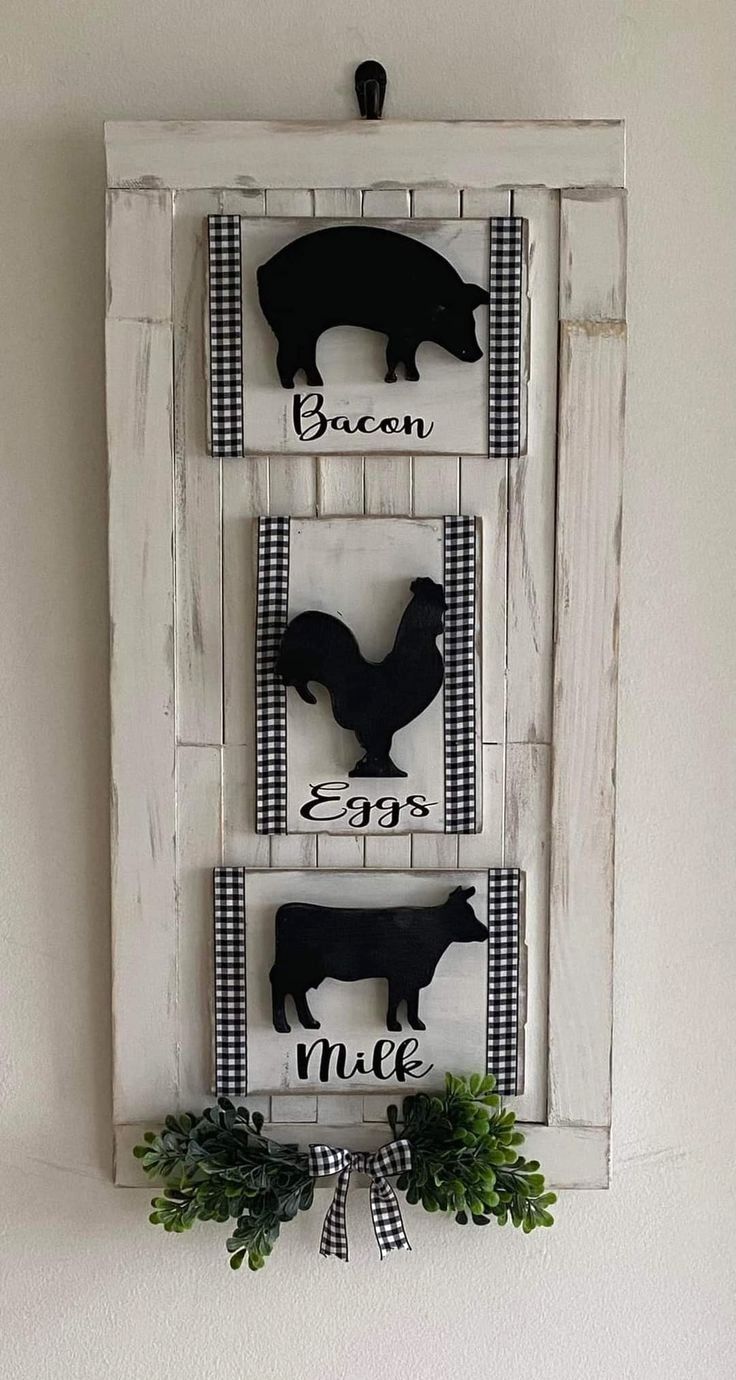 three black and white farm animals mounted to a wall