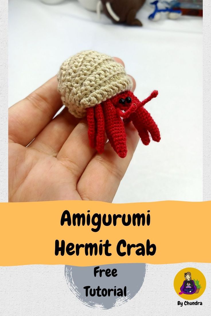 there is a small crocheted red crab in the hand