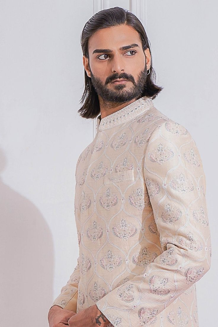 Peach sherwani with sequin, floral embroidery and full sleeves. Paired with cotton silk kurta and churidar.
Component: 3
Pattern: Embroidered
Type Of Work: Floral
Neckline: Mandarin
Sleeve Type: Full Sleeves
Fabric: Raw Silk, Cotton Silk
Color: Peach
Other Details: 
Sequin work
Patch pocket
Closure: Front concealed placket

Occasion: Groom,Wedding - Aza Fashions Peach Sherwani, Embroidered Sherwani, Blouse Yoke, Aari Embroidery, Bespoke Tailoring, Full Sleeves, Wedding Groom, Embroidered Silk, Raw Silk