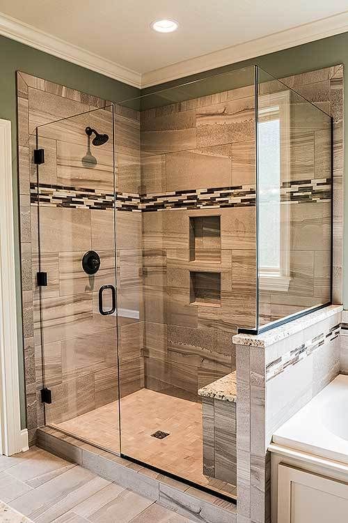 a bathroom with a walk in shower next to a bathtub and sink under a window