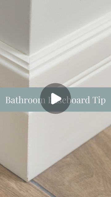 the bottom corner of a white cabinet with text that reads bathroom i eboard tip