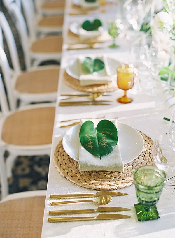 the table is set with plates and place settings