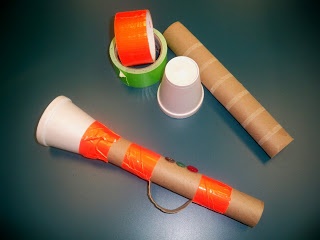 an orange and white object sitting on top of a table next to other items that are wrapped in brown paper