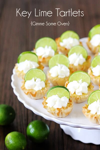 key lime tartles on a white platter with limes