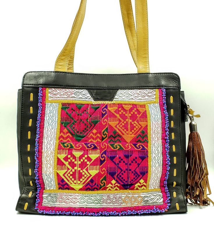 "Walk on the wild side with this gorgeous clean new Banjara embroidered leather shoulder bag from India. One of a kind! Stunning design, hand embroidered using vintage village textiles from the Banjara tribes of western India. Adorned with bead work, tassels. Banjara works are among the world's most attractive textiles - the colors, the stitches, the patterns, and their dazzling embellishments. This incredible beauty is created amidst very frugal lives. Banjara fabrics are highly collected. Own Bohemian Multicolor Leather Satchel, Traditional Leather Travel Bag, Traditional Leather Shoulder Bag, Artisan Leather Festival Bags, Traditional Top Handle Bag With Removable Pouch, Bohemian Hand-stitched Tote Shoulder Bag, Traditional Shoulder Satchel For Daily Use, Traditional Black Bag For Everyday Use, Artisan Black Bag For Daily Use