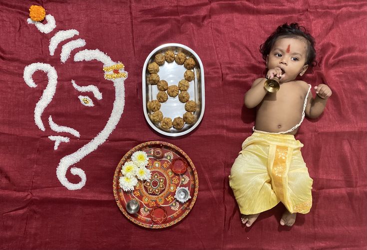 a baby is laying next to some food