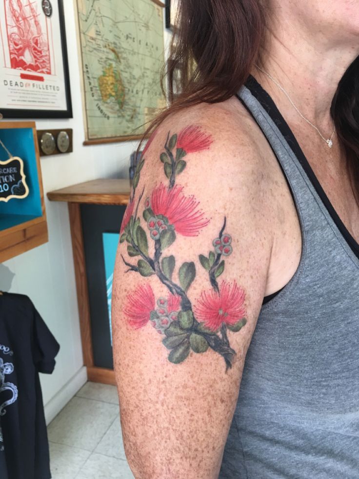 a woman with a flower tattoo on her arm