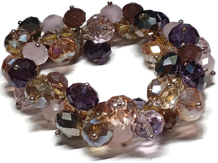 This bracelet has various shades of dark purple, lavender, and milky light purple. It measures 8 inches long by 1 inch wide. If you are someone who loves purple, this bracelet is for you! Purple Beaded Bangle Bracelets For Party, Purple Stretch Bracelet With Round Beads For Party, Purple Round Bead Crystal Bracelet For Parties, Purple Round Beads Crystal Bracelet For Party, Purple Round Beaded Crystal Bracelet For Parties, Purple Crystal Round Beads Bracelet For Party, Cluster Bracelets, Brown Jewelry, Stylish Work Outfits