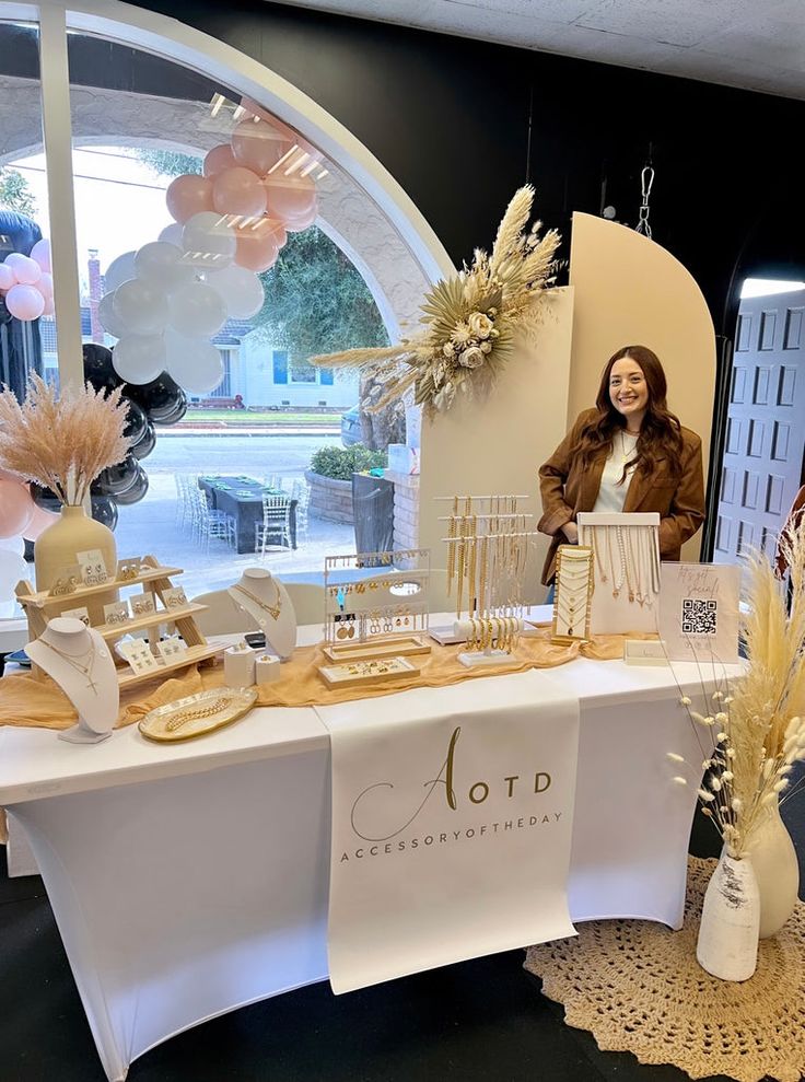 a woman standing next to a table with decorations on it and a sign that says otd