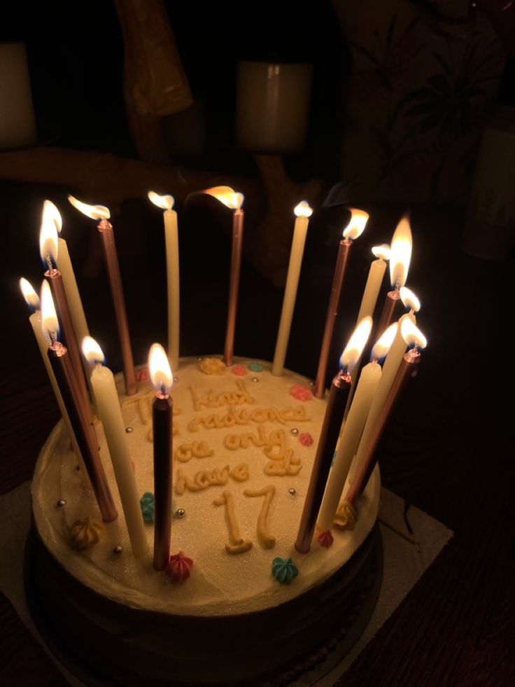 a birthday cake with lit candles on it