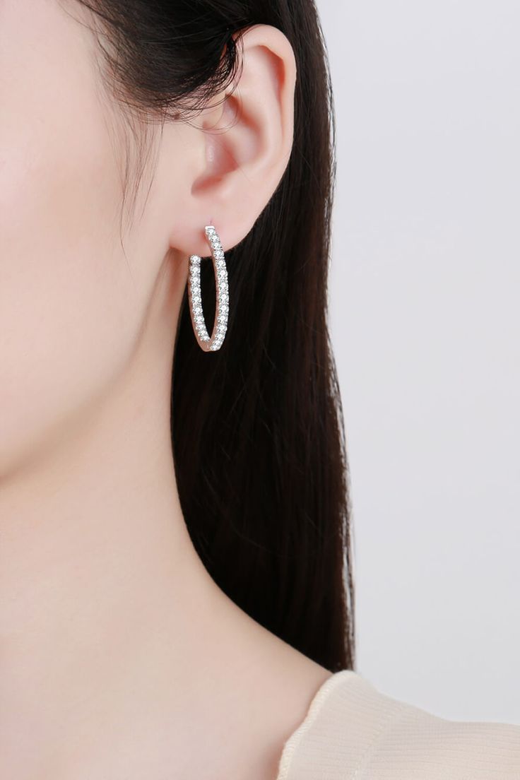 Our Rhodium-Plated Hoop Earrings are a must-have staple to your jewelry collection. Made with 925 sterling silver and moissanite, this style makes an elegant gesture to any outfit. INCLUDES: Earrings AVAILABILITY: This item may ship separately from the rest of your order NOT eligible for First Class Standard or Rush Shipping Please allow 5-10 business days for shipping No returns on jewelry FEATURES: Picture style: Ghost mannequin Style: Modern, minimalist Appearance: Round Material: 925 sterling silver, moissanite, rhodium-plated Craft: Polished Care: Avoid wearing during exercise, as sweat will react with the jewelry to produce silver chloride and copper sulfide. Imported Including: A matching box. Product measurements: Inner diameter: 1 in. Width: 0.1 in (0.25 cm). Weight: 0.3 oz (8.6 g Ghost Mannequin, Picture Style, Moissanite Jewelry, Sterling Silver Hoop Earrings, Diamond Hoop Earrings, Sterling Silver Hoops, Girls Jewelry, Silver Hoops, Silver Hoop Earrings