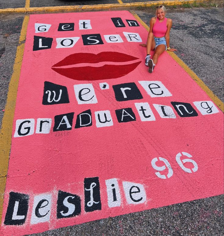 a woman sitting on top of a pink rug with words written in black and white