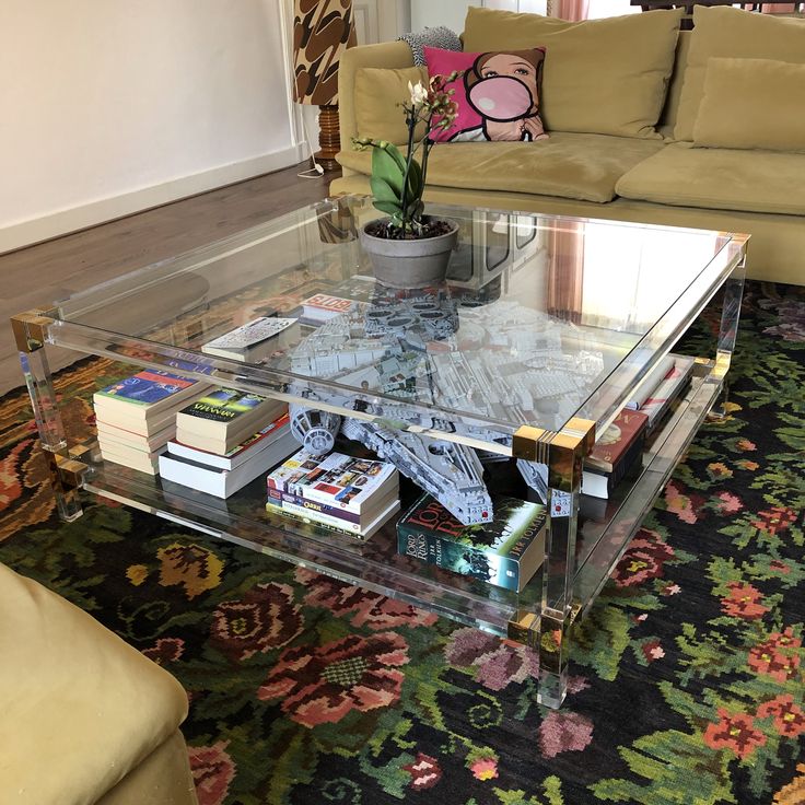 a glass coffee table with books on it