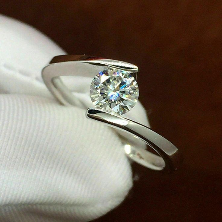 a diamond ring sitting on top of a white cloth