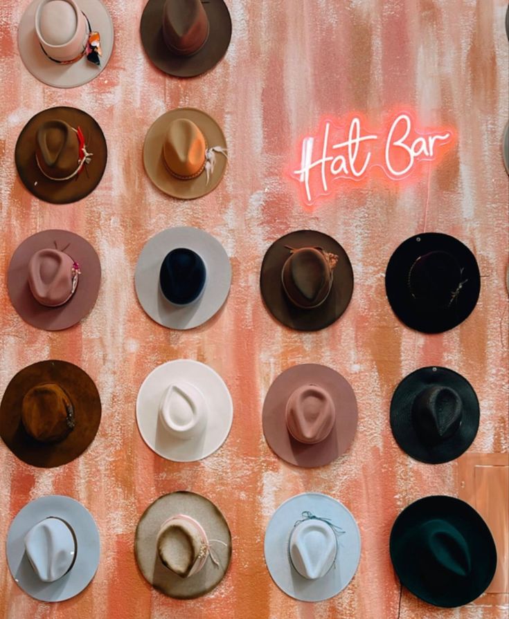 several hats are arranged on a wall with the words hat bar written above them